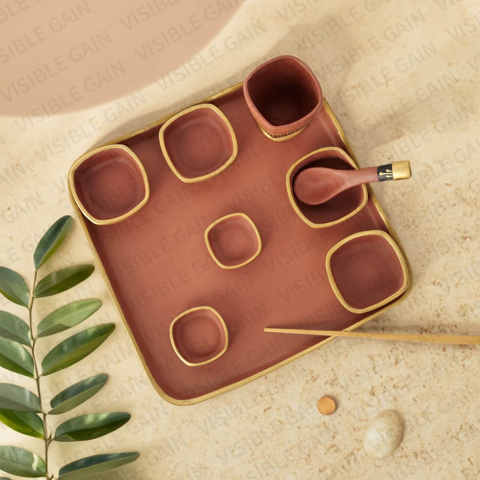 Handmade ceramic dining set in earthy colors shown in a product photoshoot